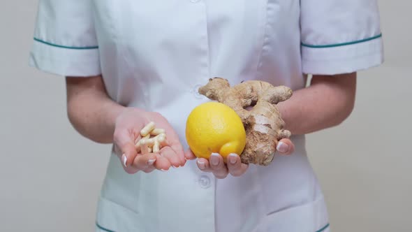 Nutritionist Doctor Healthy Lifestyle Concept - Holding Ginger Root, Lemon and Vitamin Pills
