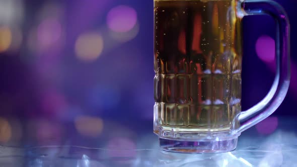 Mug of light beer on the bar counter at a pub party.