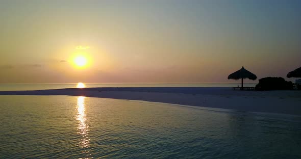 Natural birds eye travel shot of a sunshine white sandy paradise beach and aqua blue water backgroun