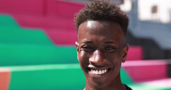 Young african man smiling on camera outdoor