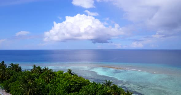 Daytime drone copy space shot of a paradise sunny white sand beach and aqua blue water background in