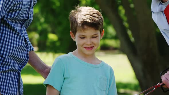 Multi-generation family preparing food on barbecue