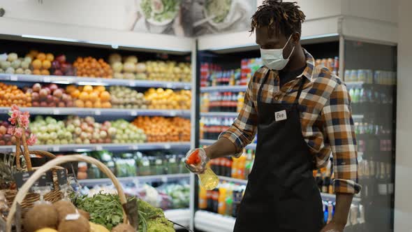 African American Worker Refreshing Greens in the Store Spraying Cool Vapor in Supermarket