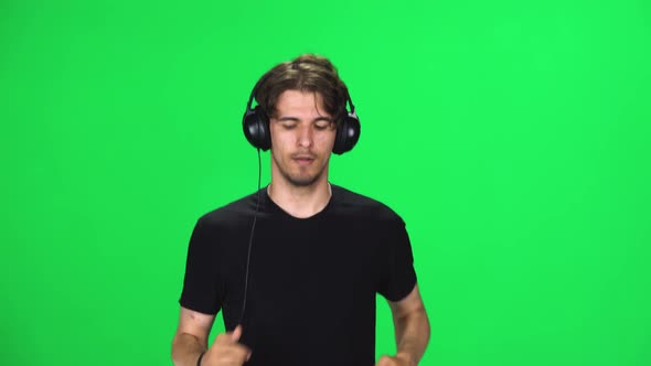 Brunette Guy in Big Headphones Is Running, Chroma Key