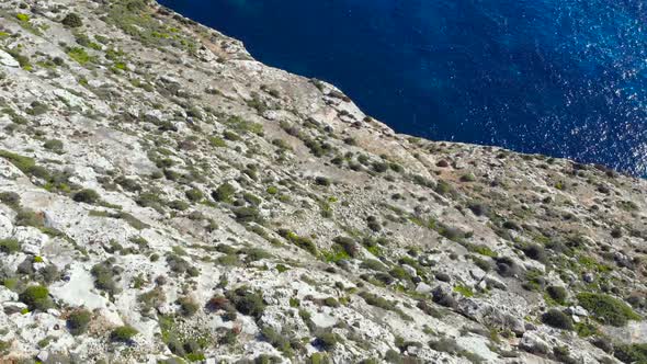 Drone shot over rocks in nature with rocks and the Mediterranean sea of Malta 3