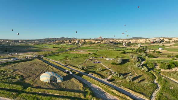 4K Aerial view of Goreme. Colorful hot air balloons fly over the valleys.