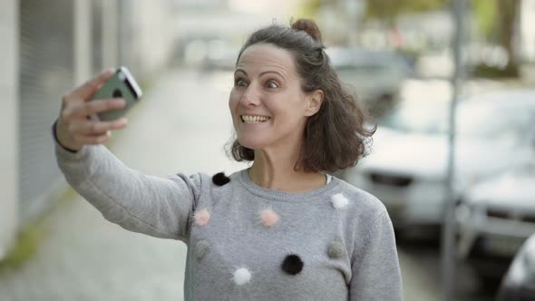 Happy Middle Aged Woman Having Video Call Through Phone