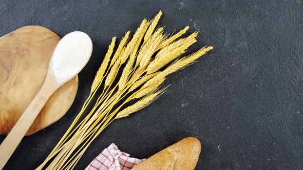 Baguette wrapped in napkin and wheat grains