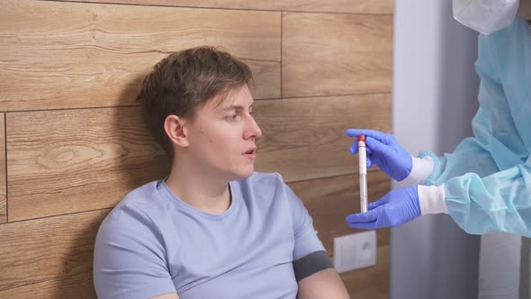 Young Man at Home Taking a Test for COVID19 By Female Doctor