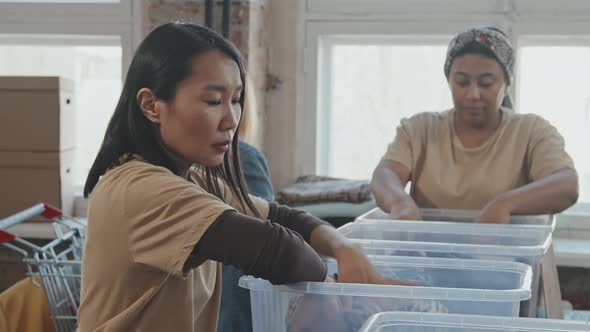 Volunteers Looking through Donated Clothes