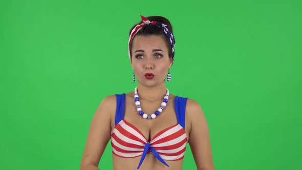 Portrait of Beautiful Girl in a Swimsuit Confused Saying Oops and Shrugging. Green Screen