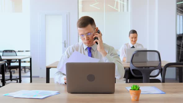 Frustrated Office Worker Is Arguing on Phone