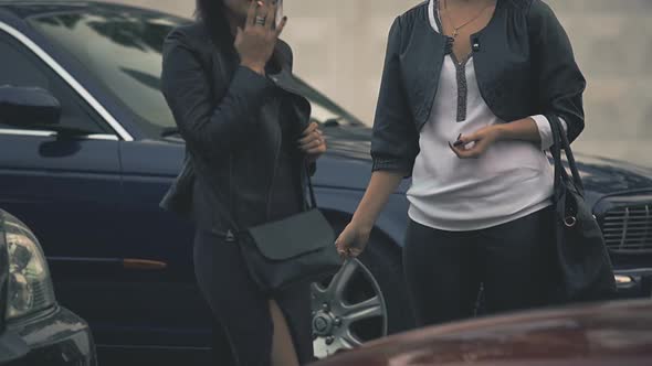 Pair of Young Females Harm Their Health with Tobacco, Smoking Next to Fancy Car