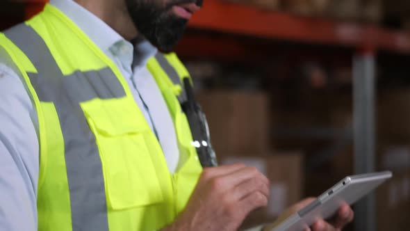 Man Warehouse Worker Using Tablet During Inventory