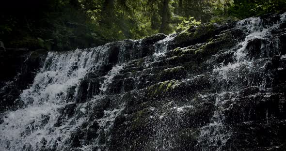 Stunning Slow Establishing Shot of River with Waterfall in Forest in Summer. Slow Motion V4