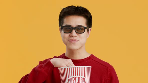 Cheerful Asian Man Wearing 3D Glasses Watching Film Yellow Background