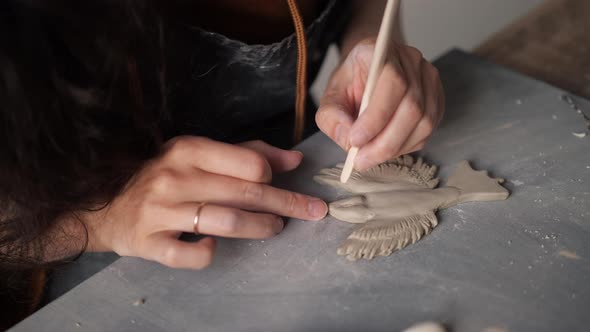 Close Up Top View of Potter Female Hands Working on Details of a Clay Handcraft Bird