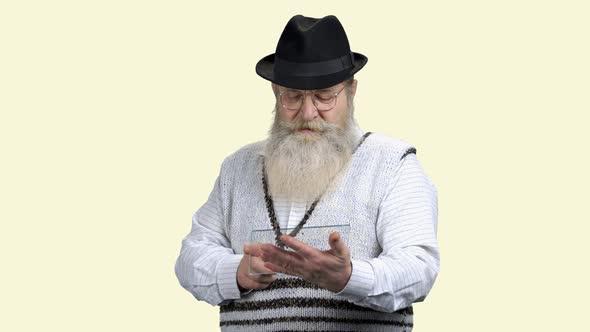 Senior Man with Beard Using Transparent Plastic Device