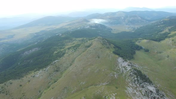 Aerial view of smoke rising above Dinara mountain tops