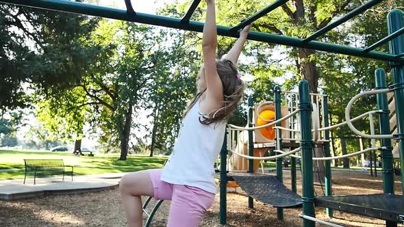 Blonde girl falls in slow motion from monkey bars