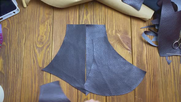 Top View of Woman Hands Lays Out Pieces of Ecoleather on Wooden Table