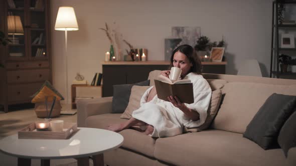 Woman Spending Evening At Home With Book