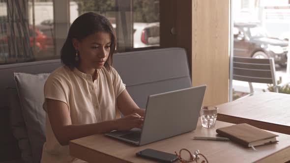 Woman Typing Email on Laptop