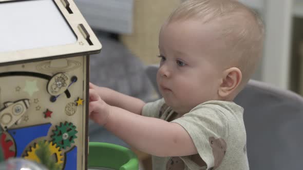 Child Having Fun Playing with Wooden Busy Board Happy Kid Play with Educational Learning Toy Enjoy