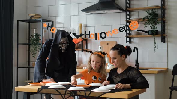 Family Playing Pumpkin Memory Game in Halloween