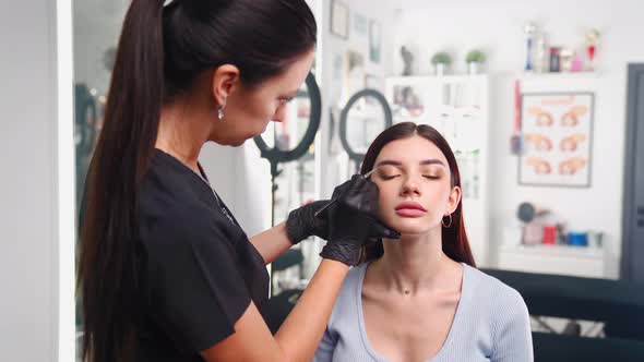 Permanent Makeup Master Prepares Woman Client for Eyebrow Microblading Procedure