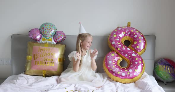 Indoor Shot of Pretty Joyful Cute Adorable Girl Kid Celebrating Eight Years Old Birthday with Bright