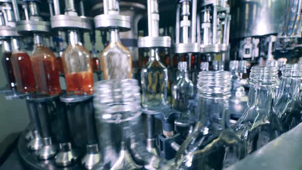 Factory Mechanism Is Pouring Alcohol Into Empty Bottles