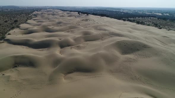 Drone aerial dolly out shot of sam sand dune desert in jaisalmer, Rajasthan, India.