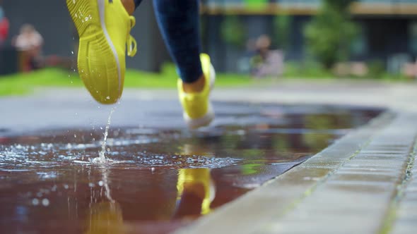 Female Sports Woman Jogging Outdoors Stepping Into Puddle