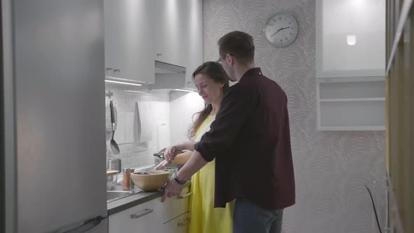 Sweet Couple Preparing Dinner Together in Modern Kitchen