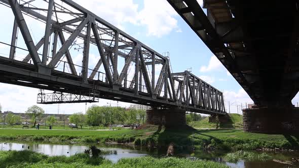 Railway bridge over the river, bottom view in the summer