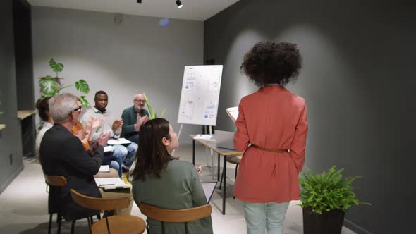 Afro-American Female Business Coach Entering Seminar Room