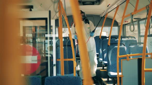 Sanitation Worker Is Disinfecting Bus From Inside