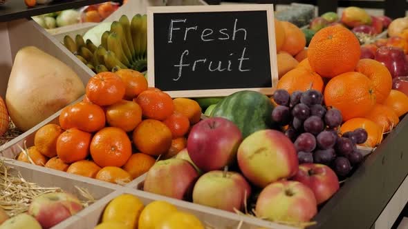 Various Fruits in Boxes on Shelves on a Nameplate the Inscription FRESH FRUITS