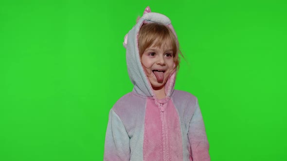 Child Girl in Unicorn Pajamas Making Silly Funny Faces Fooling Around Showing Tongue on Chroma Key