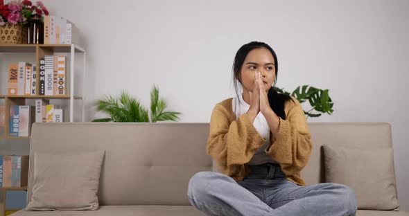 Girl headache while sitting on couch