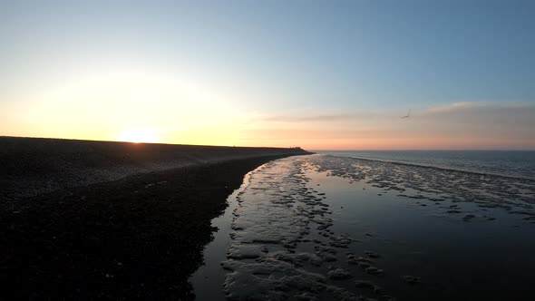 Aerial drone scenic view by the sunrise on the shore