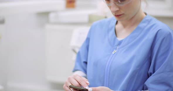 Female Doctor Using Mobile at Healthcare Clinic