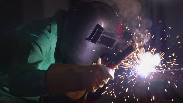 Metal Welder Working with Arc Welding Machine