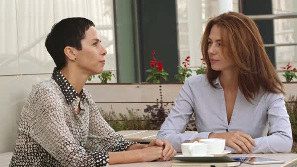 Businesswomen in Street Cafe