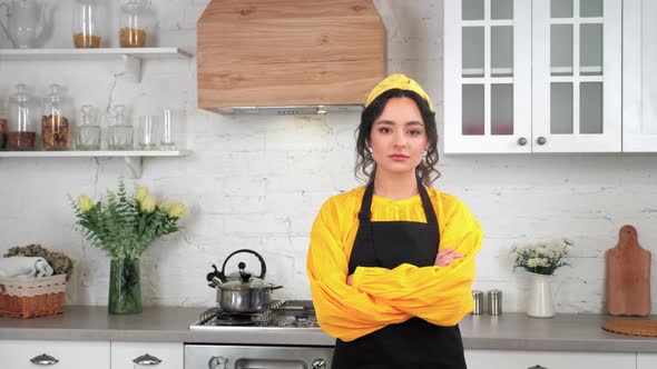 Portrait Serious Housewife Crossing Hands Looking Camera in Home Modern Kitchen