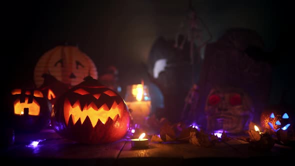 Flashlight Beam Is Lighting Halloween Pumpkins and Candles at the Table