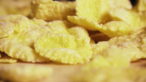 Slow Corn Flakes Are Falling on the Table Close-up