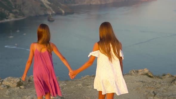 Children Outdoor on Edge of Cliff Seashore