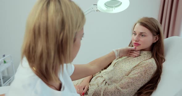 Woman Dermatologist Directing Lamp to Woman Face During Checking Skin Elasticity or Making Skin